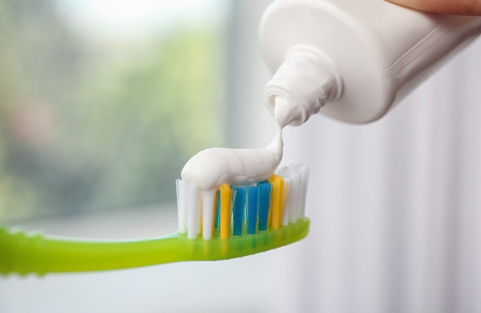 Redlemon Applying Paste On Toothbrush Against Blurred Backg 2026 03 05 11 49 56 Utc Compressed