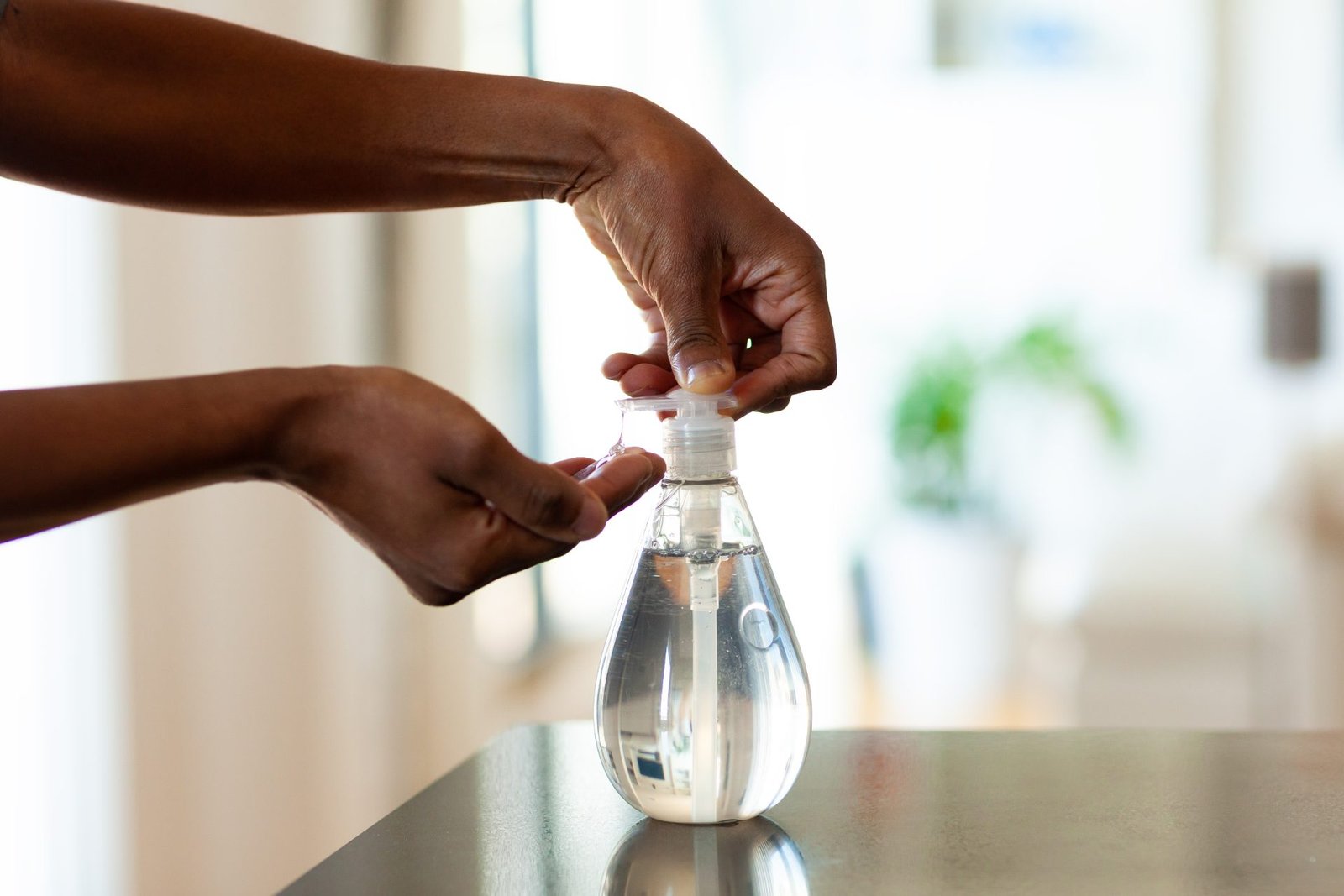Redlemon Dispensing Clear Hand Sanitizer In A Bright Room 2026 03 16 22 56 18 Utc Compressed