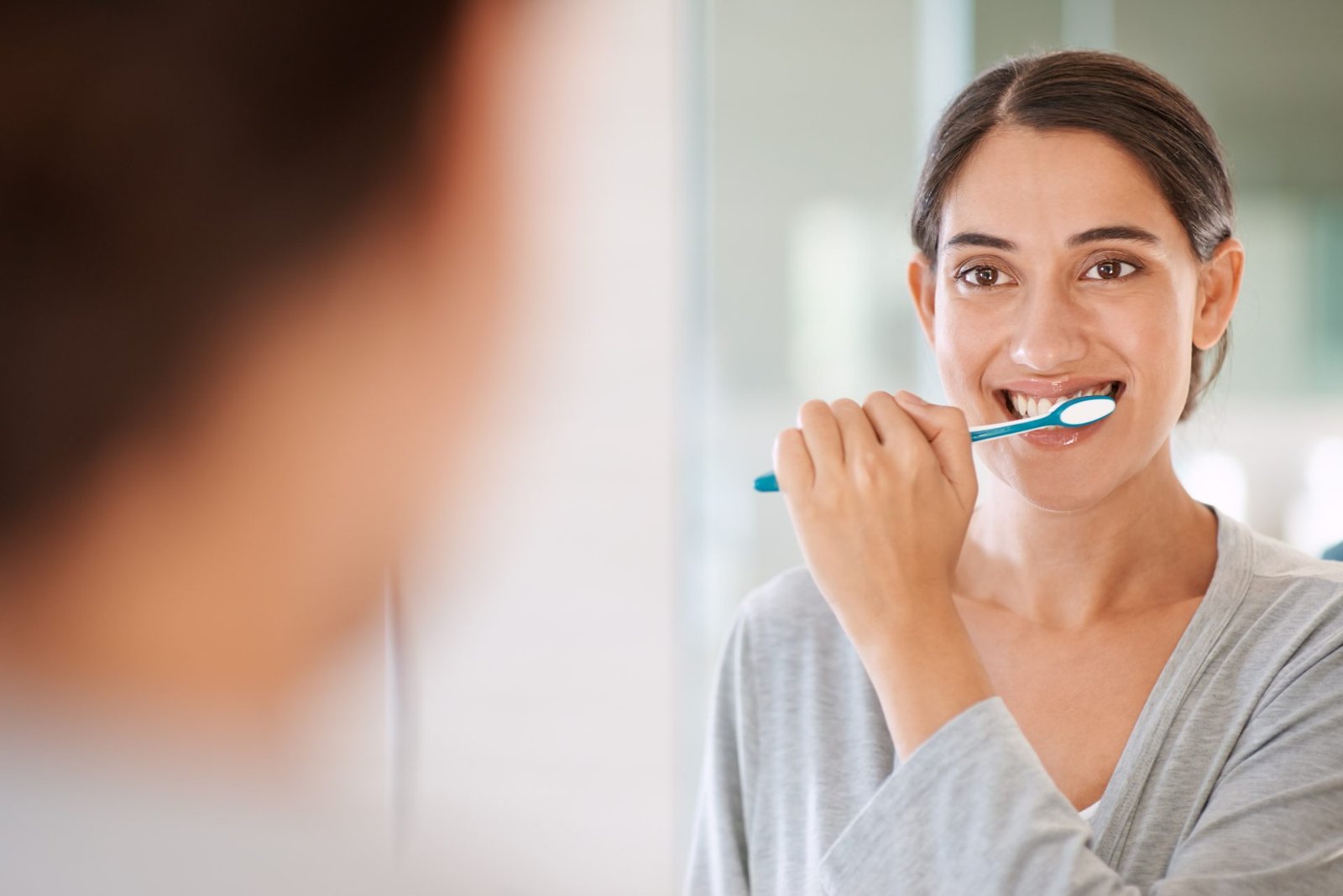 Redlemon Woman Brushing Teeth In The Bathroom Mirror 2026 01 09 09 52 01 Utc Compressed